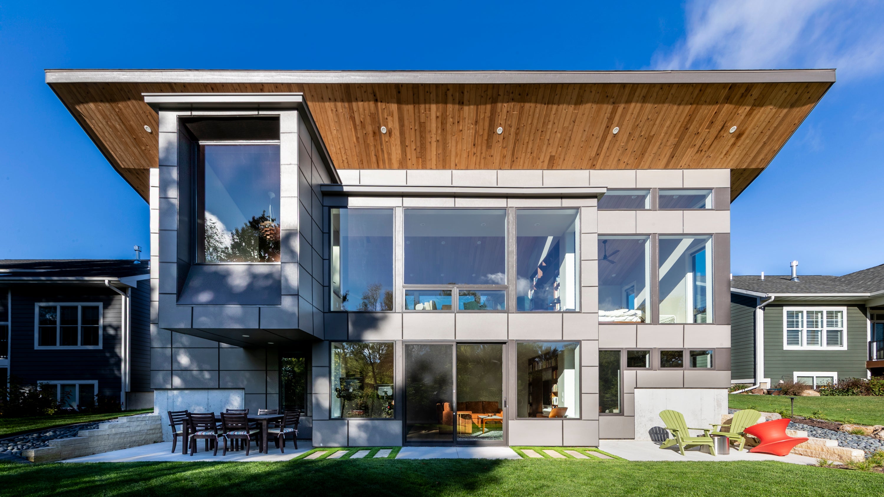 Modern Prairie style house with glass facade and wooden roof